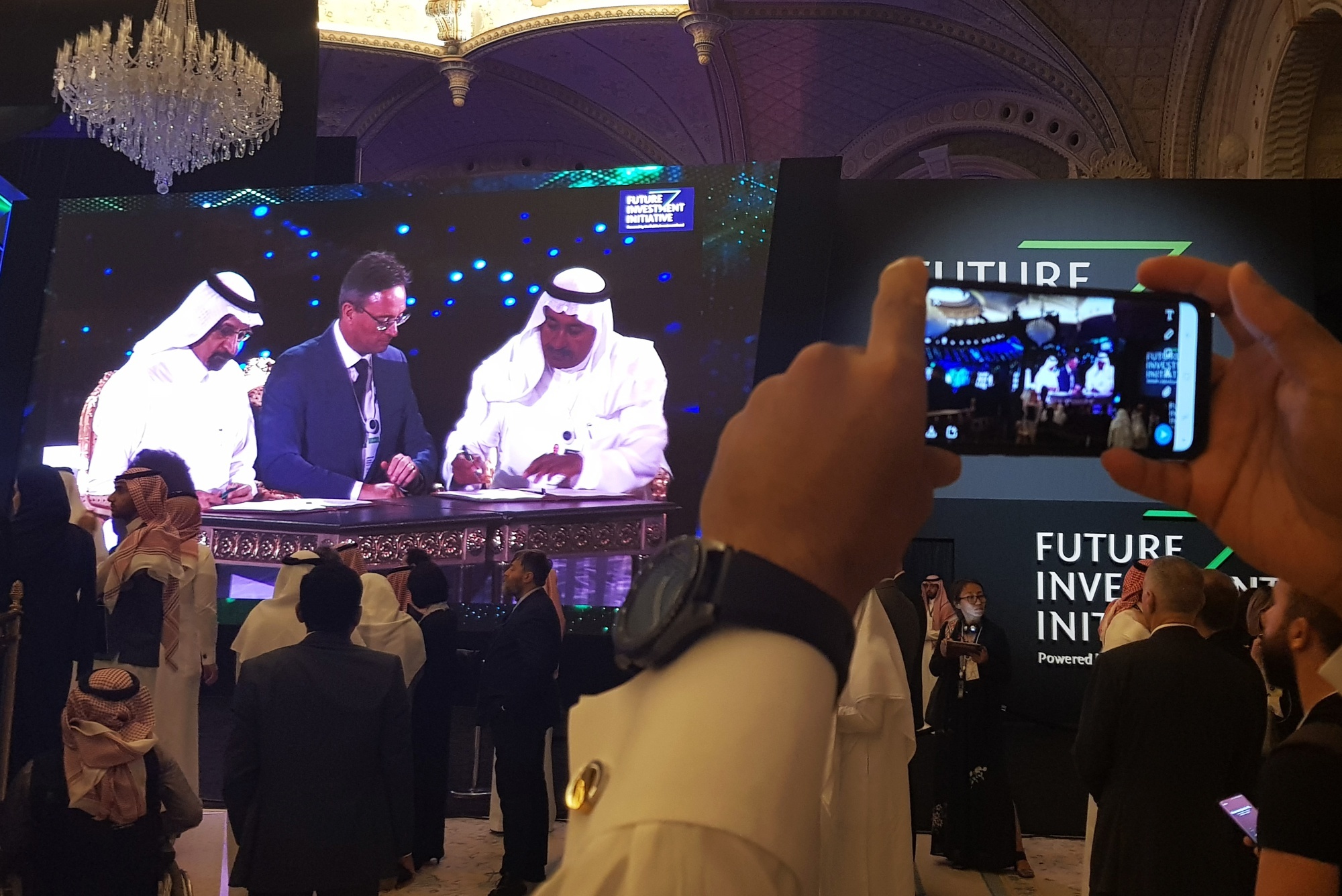 Jeremy Weir, chief executive officer of Trafigura Group, center, signs a deal at the Future Investment Initiative (FII) conference at the Ritz Carlton Hotel in Riyadh, Saudi Arabia, on Tuesday, Oct. 23, 2018. Photographer: Javier Blas/Bloomberg