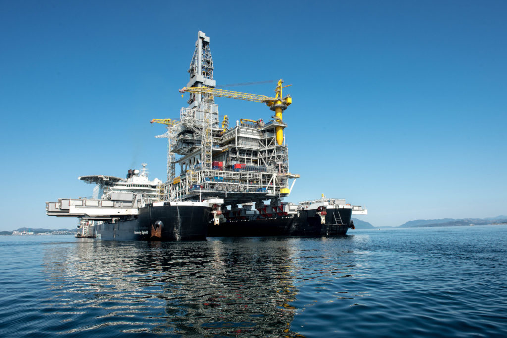 An oil drilling platform sits on board the world's largest construction vessel, the Pioneering Spirit, in the Bomla fjord near Leirvik, ahead of its transportation to the Johan Sverdrup oil field, Norway, on Friday, June 1, 2018. Equinor ASA has reduced the break-even price to below $20 a barrel in its flagship Johan Sverdrup oil project in the North Sea. Photographer: Carina Johansen/Bloomberg