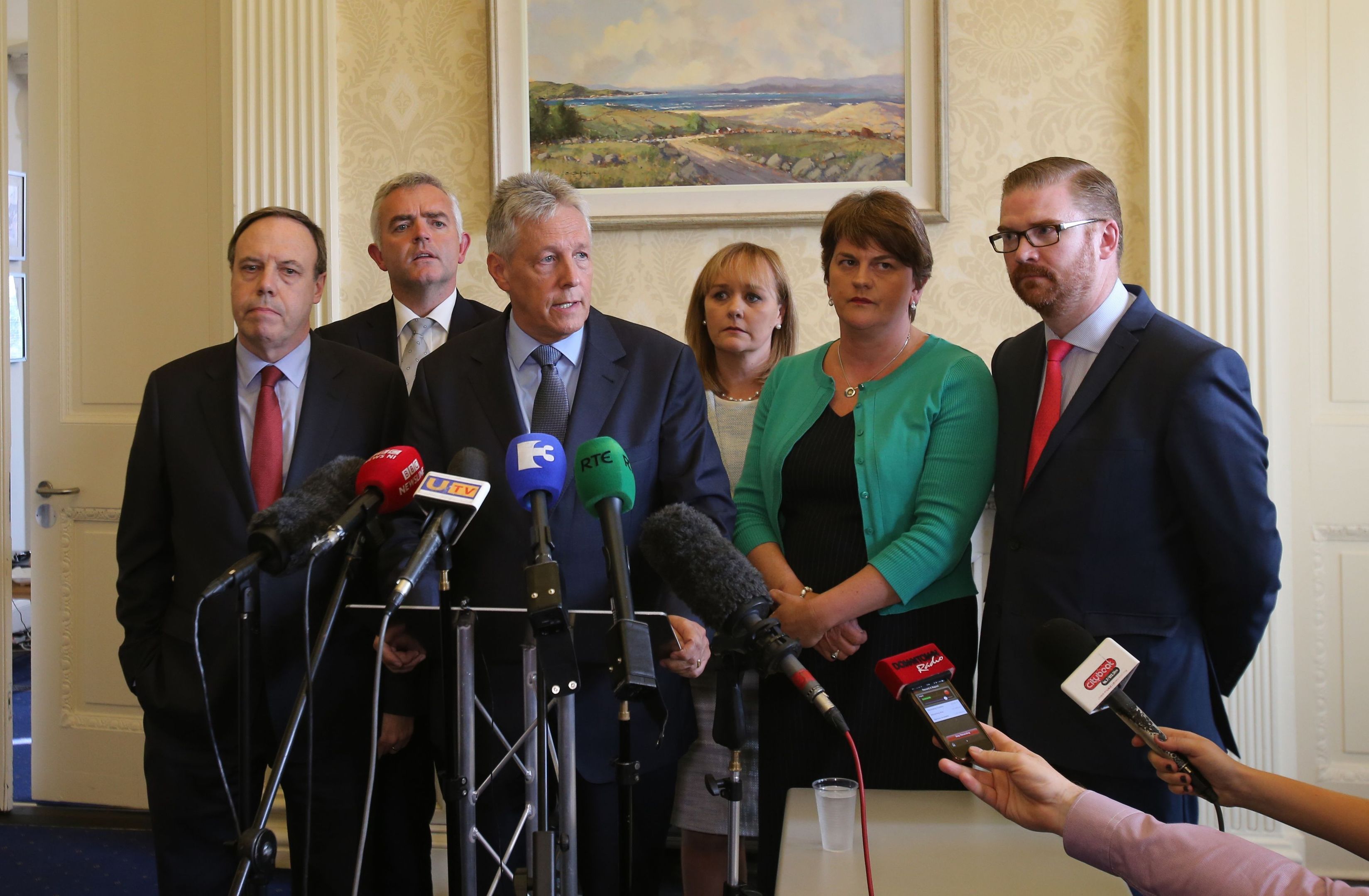 First Minister Peter Robinson at Stormont, Belfast, watched by Nigel Dodds, Johnathan Bell, Michelle Mcilveen, Arlene Foster and Simon Hamilton,  announces that he is standing aside, and the majority of his Democratic Unionist ministers are to resign, with party colleague Arlene Foster to take over as acting First Minister. PRESS ASSOCIATION Photo. Picture date: Thursday September 10, 2015. The surprise move from the DUP leader comes amid an Assembly crisis in the wake of a murder linked to the IRA murder. See PA story ULSTER Politics. Photo credit should read: Niall Carson/PA Wire