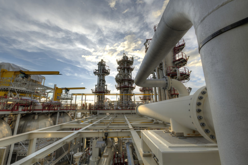 HDR photo from a oil industy process plant. The picture showes pipes, columns, and other technical equipment.