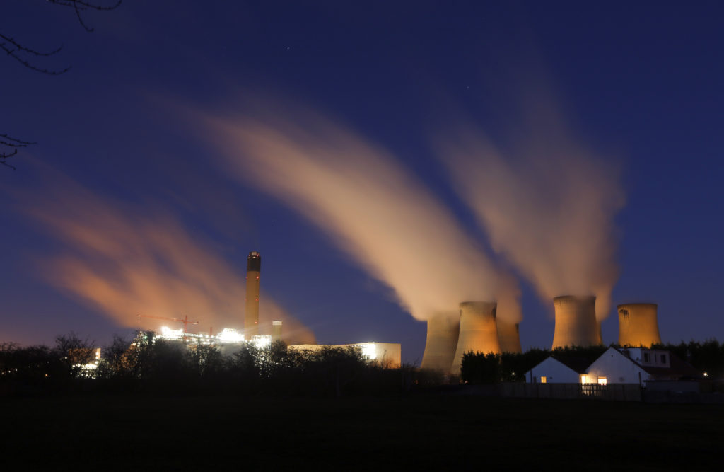Vapour rises from cooling towers at Drax Power Station, operated by Drax Group Plc, at night in Selby, U.K. Photographer: Chris Ratcliffe/Bloomberg
