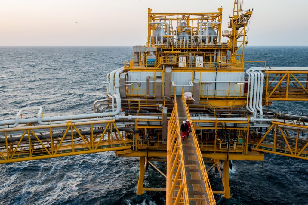 Workers cross a walkway between zones aboard an offshore oil platform in the Persian Gulf's Salman Oil Field, operated by the National Iranian Offshore Oil Co., near Lavan island, Iran, on Thursday, Jan. 5. 2017. Nov. 5 is the day when sweeping U.S. sanctions on Irans energy and banking sectors go back into effect after Trumps decision in May to walk away from the six-nation deal with Iran that suspended them. Photographer: Ali Mohammadi/Bloomberg