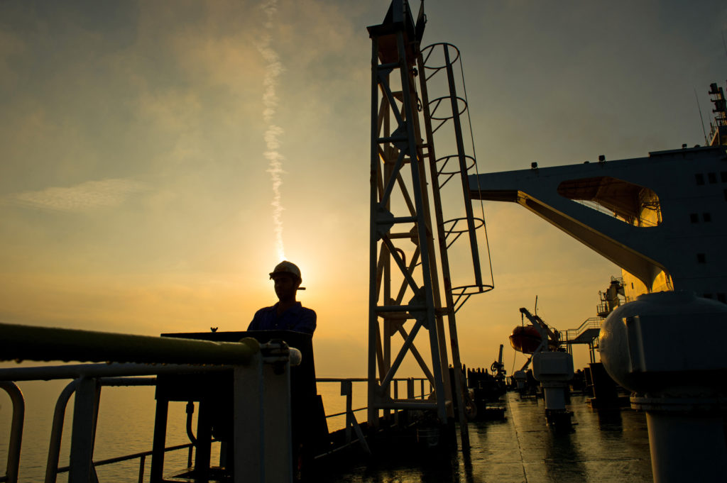 A crew man stands on the deck of the crude oil tanker 'Devon' as it sails through the Persian Gulf towards Kharq Island oil terminal to transport crude oil to export markets in the Persian Gulf, Iran, on Friday, March 23, 2018. Photographer: Ali Mohammadi/Bloomberg