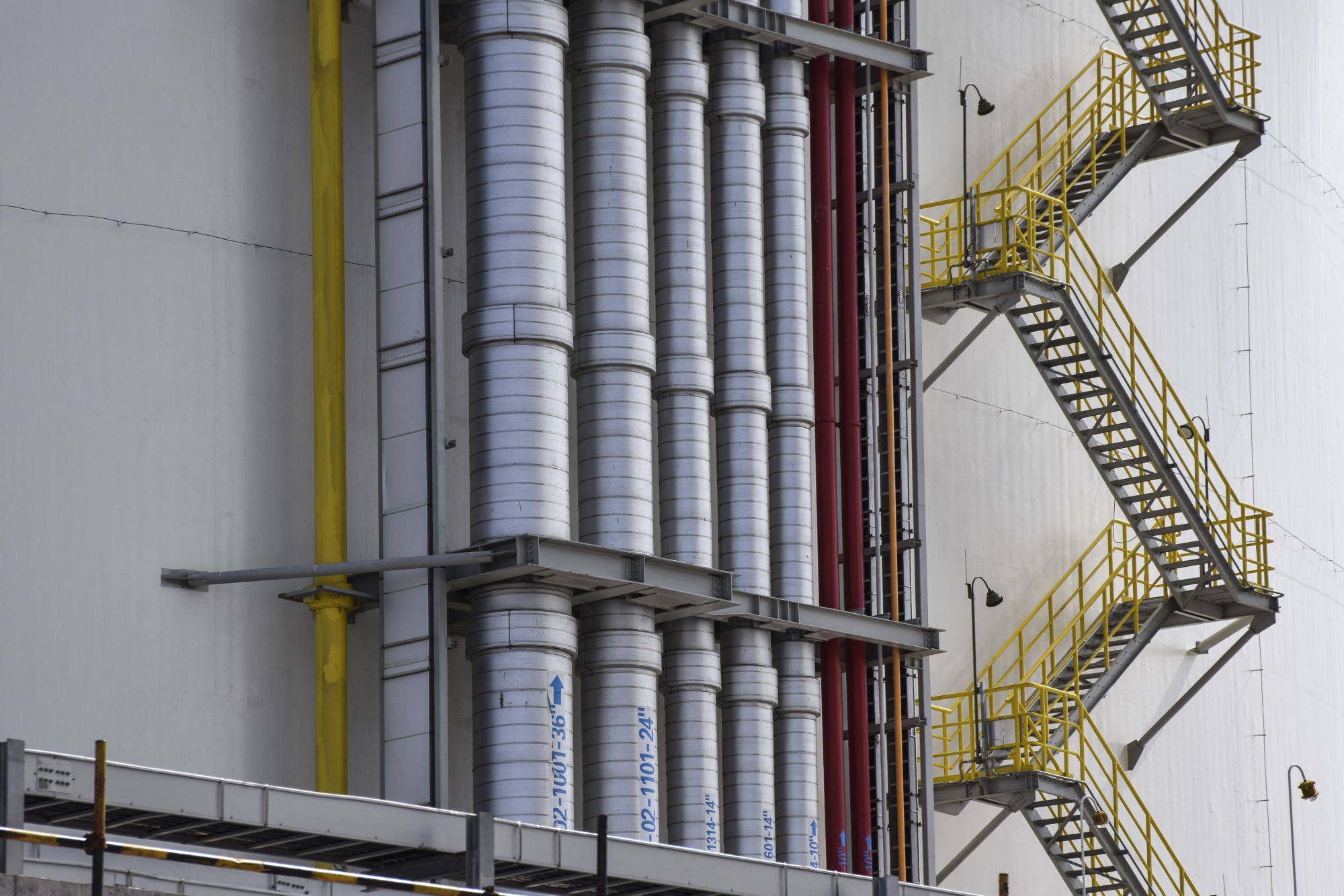 Pipework stands outside of a liquefied natural gas (LNG) cylindrical storage tank at ENN Energy Holdings Ltd.'s LNG terminal on Zhoushan Island, Zhejiang province, China, on Thursday, Nov. 1, 2018. Gas is in such hot demand in China right now its allowing a quirky market to flourish: transporting the fuel on trucks. The countrys top suppliers are loading liquefied natural gas onto tanker trucks and delivering it to users to make up for insufficient pipeline coverage inland. Photographer: Qilai Shen/Bloomberg