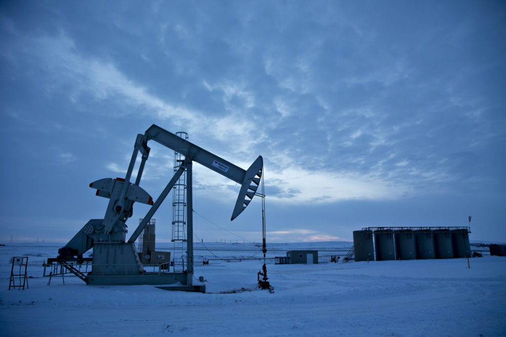A pumpjack operates above an oil well in the Bakken Formation outside Williston, North Dakota, U.S., on Friday, March 9, 2018.  Photographer: Daniel Acker/Bloomberg
