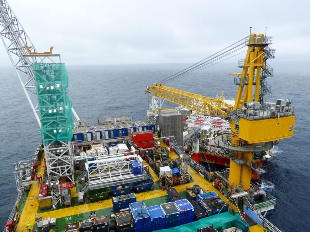 The Johan Sverdrup riser platform, operated by Equinor ASA, center, and the Safe Zephyrus mobile accommodation unit, operated by Prosafe SE, stand in the Johan Sverdrup offshore oil field, about 160 kilometers (100 miles) west of Norways oil capital, Stavanger, Norway, on Wednesday, Aug. 22, 2018. When Sverdrup reaches maximum production of 660,000 barrels a day by the middle of the next decade, it will make up about 40 percent of the countrys total oil and gas output, according to Equinor ASA. Photographer: Mikael Holter/Bloomberg