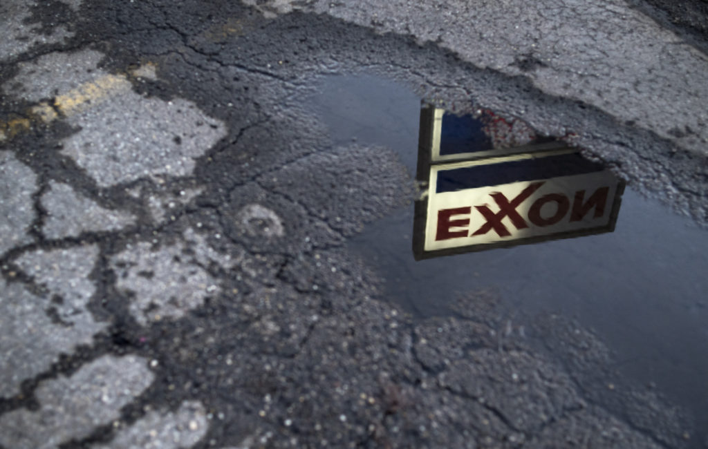 Exxon sign reflected in puddle