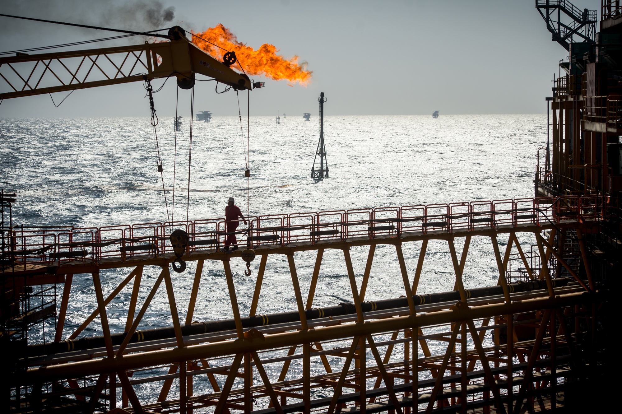 A gas flare burns from a pipe aboard an offshore oil platform in the Persian Gulf's Salman Oil Field, operated by the National Iranian Offshore Oil Co., near Lavan island, Iran, on Thursday, Jan. 5. 2017. Nov. 5 is the day when sweeping U.S. sanctions on Irans energy and banking sectors go back into effect after Trumps decision in May to walk away from the six-nation deal with Iran that suspended them. Photographer: Ali Mohammadi/Bloomberg