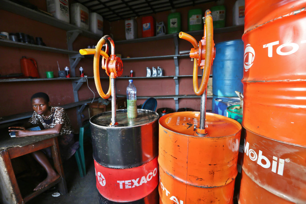 Oil barrels with logos and pumps