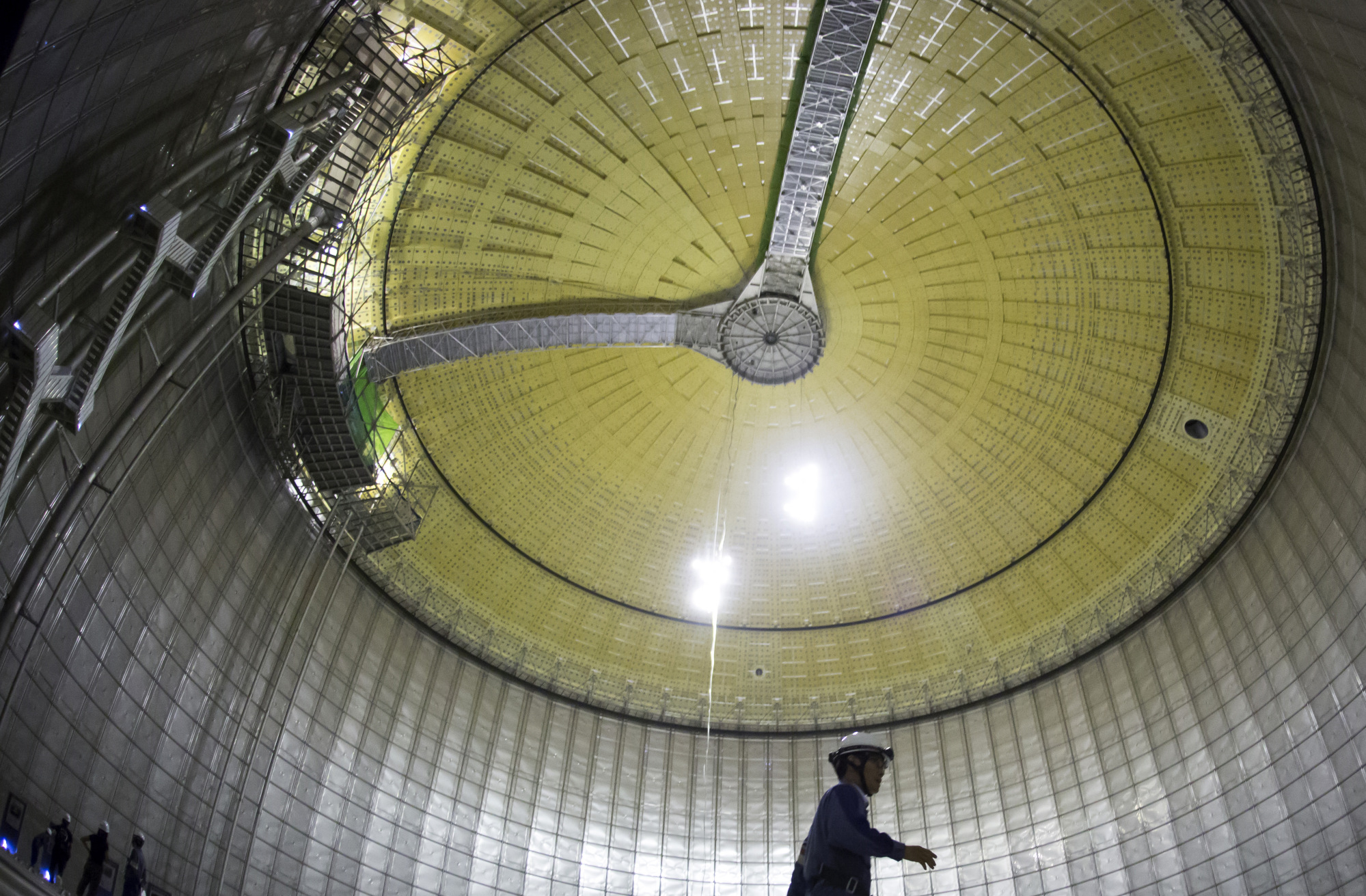 A Tokyo Electric Power Co. (Tepco) employee walks inside the company's liquefied natural gas (LNG) storage tank as it stands under construction at the Futtsu gas-fired thermal power plant in Futtsu, Chiba Prefecture, Japan, on Monday, Sept. 10, 2018.  Photographer: Tomohiro Ohsumi/Bloomberg