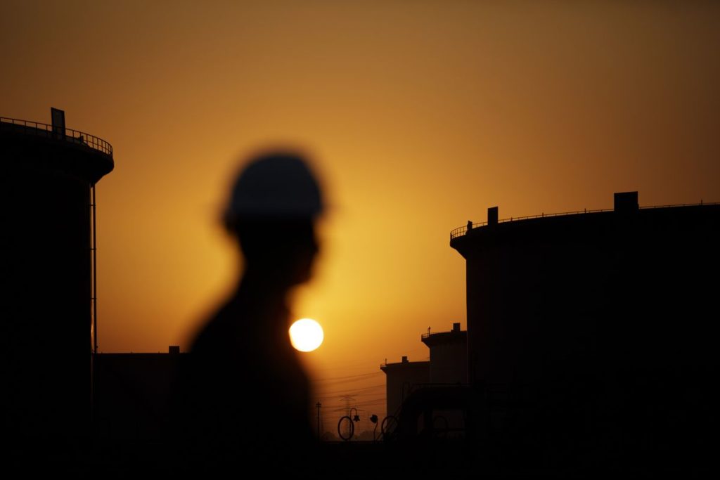 The sun sets over crude oil storage tanks at the Juaymah tank farm, operated by Saudi Aramco, in Ras Tanura, Saudi Arabia, on Monday, Oct. 1, 2018.