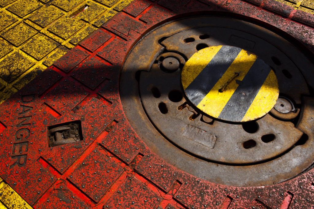 A danger sign sits on the floor beside the covered oil drilling access hole on the Casablanca oil platform, operated by Repsol SA, in the Mediterranean Sea off the coast of Tarragona, Spain. Photographer: Angel Navarrete/Bloomberg