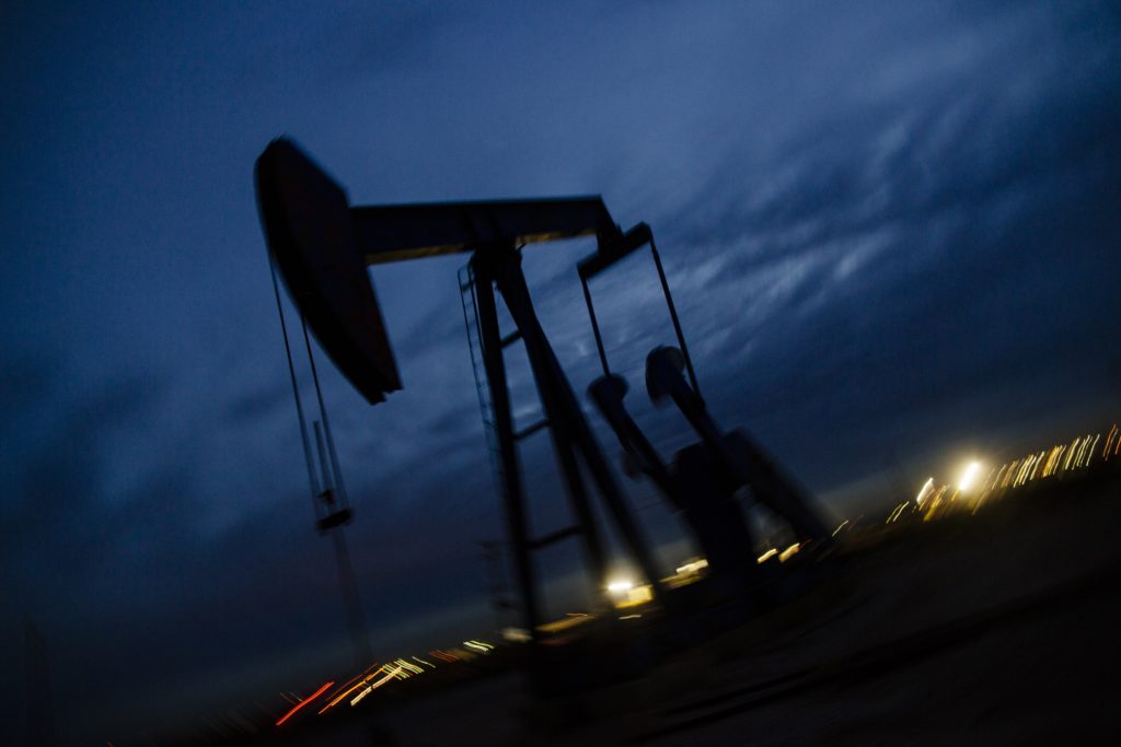 A pump jack stands at dusk in the Permian Basin area of Loving County, Texas, U.S., on Sunday, Dec. 16, 2018. Photographer: Angus Mordant/Bloomberg