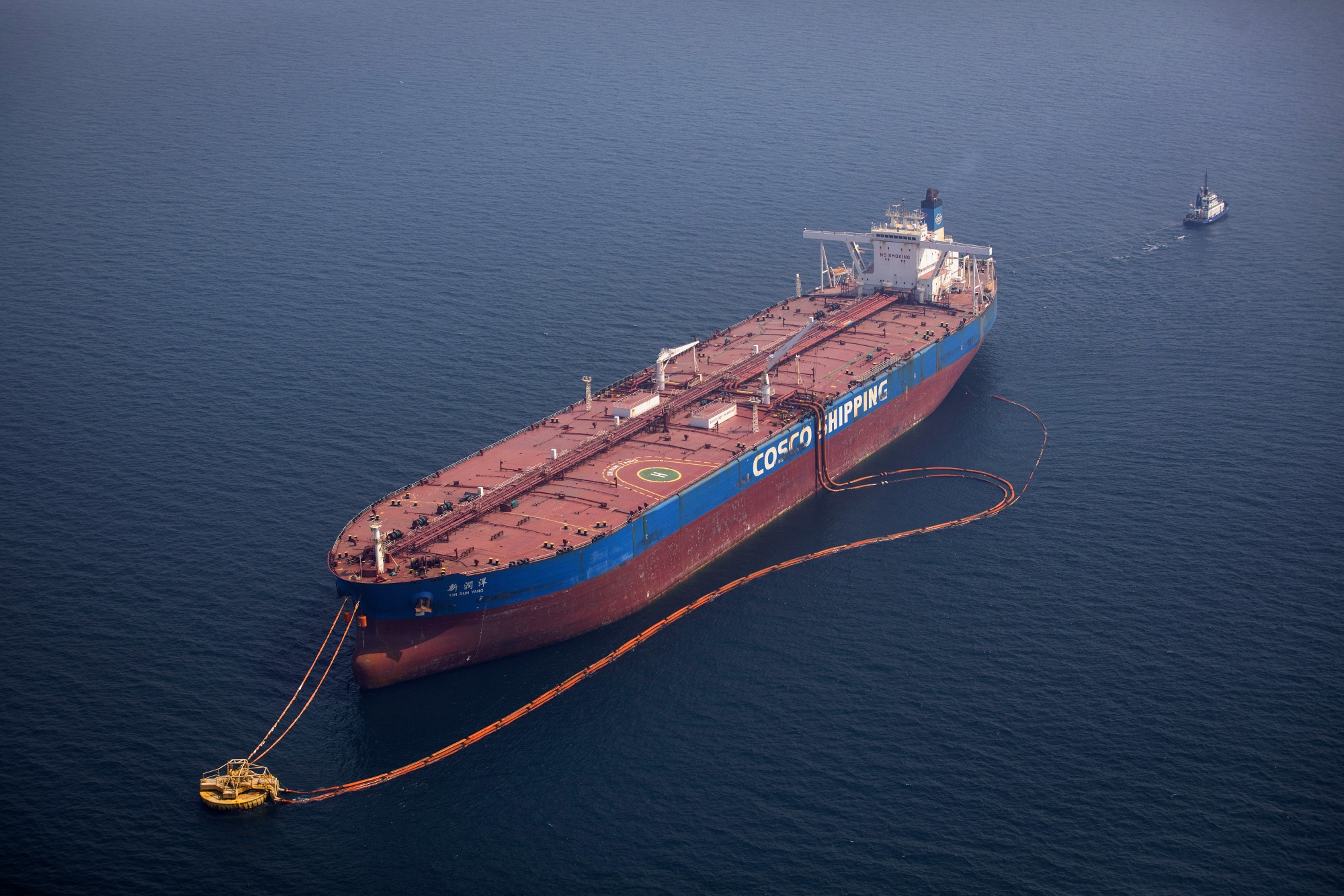 The 'Xin Run Yang' oil tanker, operated by Cosco Shipping Holdings Co., rides its mooring while being loaded with crude oil near Saudi Aramco's Ras Tanura oil refinery, in Ras Tanura, Saudi Arabia, on Wednesday, Oct. 3, 2018. Saudi Aramco aims to become a global refiner and chemical maker, seeking to profit from parts of the oil industry where demand is growing the fastest while also underpinning the kingdoms economic diversification. Photographer: Simon Dawson/Bloomberg