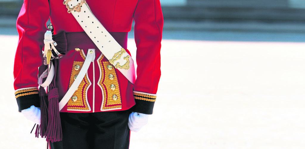 Queen's Guard march down the Mall in London - outside Buckingham Palace. Queen's guard (Life Guards regiment) standing to attention outside of Buckingham Palace, at the Trooping the Colour on the Queen's official 85th Birthday in Central London.