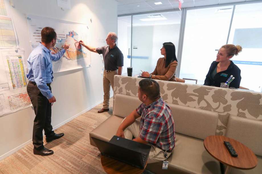 Newfield Exploration employees us e the colaboration area Tuesday, Oct. 10, 2017, in The Woodlands ( Steve Gonzales / Houston Chronicle )