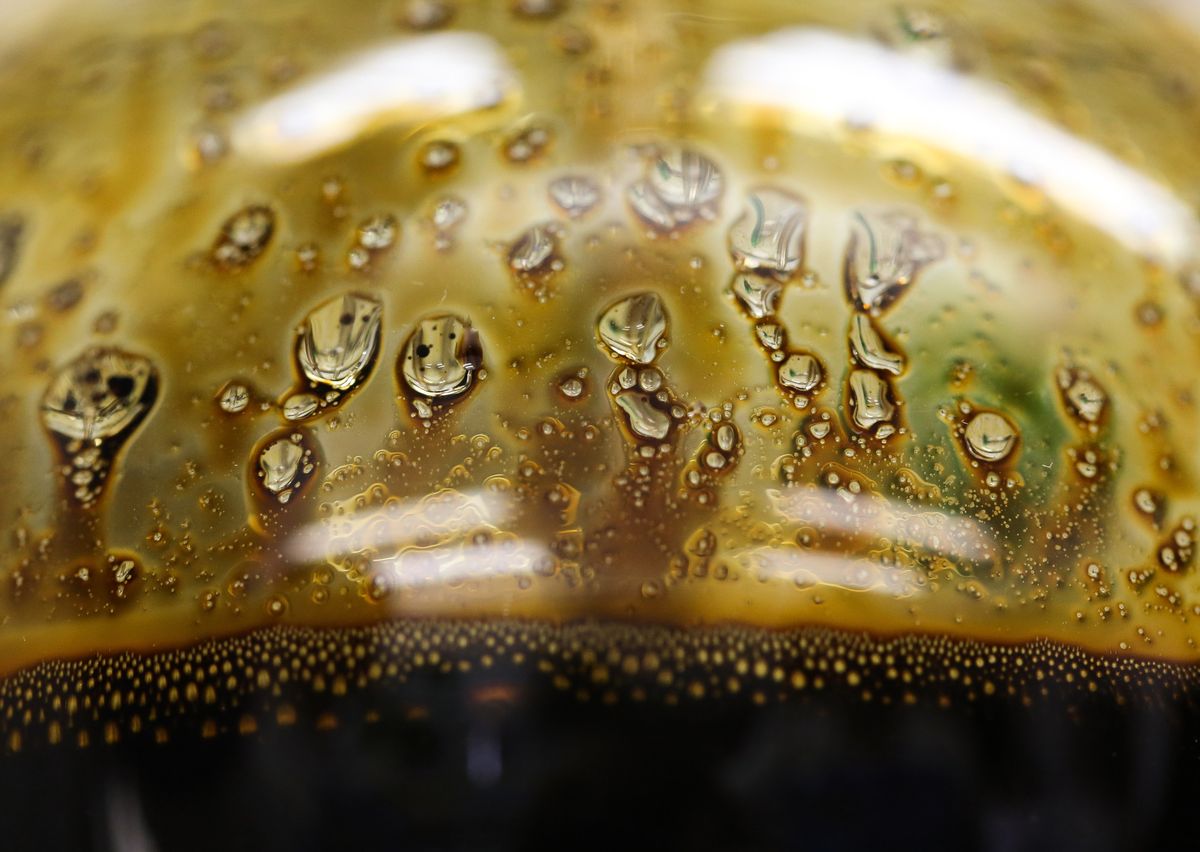 A sample of crude oil sits in a glass flask during testing for chloride salt content in a laboratory in an oilfield in Russia. Photographer: Andrey Rudakov/Bloomberg