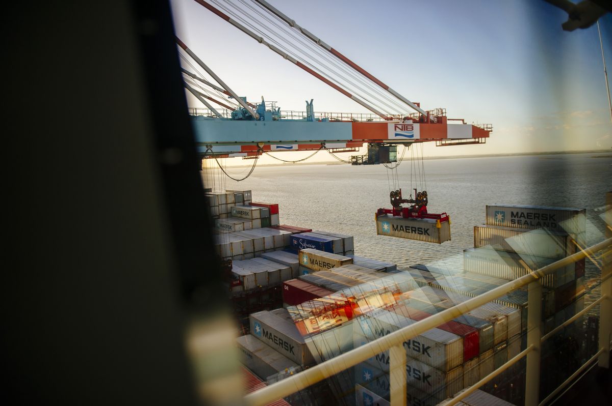 Shipping containers are unloaded from the deck of the Maersk Mc-Kinney Moeller Triple-E Class container ship, operated by A.P. Moeller-Maersk A/S, in the Port of Bremerhaven in Bremerhaven, Germany. Photographer: Kristian Helgesen/Bloomberg