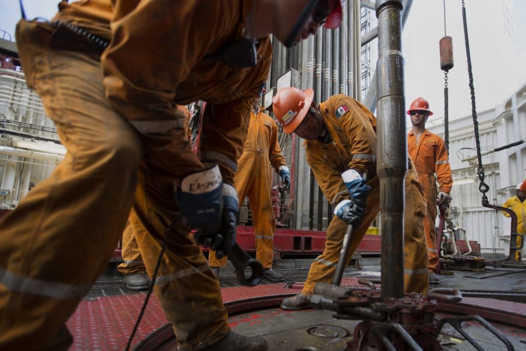 Workers prepare drilling pipe on the Petroleos Mexicanos (Pemex) La Muralla IV deep sea crude oil platform in the waters off Veracruz, Mexico, on Friday, Aug. 30, 2013.  Photographer: Susana Gonzalez/Bloomberg