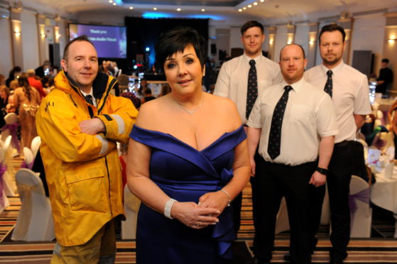 Audrey Wood, centre, with members of the RNLI crew