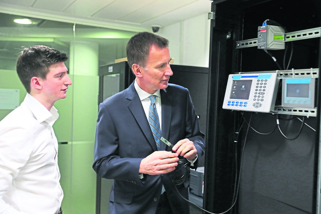 Foreign Secretary Jeremy Hunt creates a cyber attack during a demonstration with student Marco Cook as he visits the Sir Alwyn Williams Building at the University of Glasgow ahead of his speech on Defending Democracy in the Cyber Age. PRESS ASSOCIATION Photo. Picture date: Thursday March 7, 2019. See PA story POLITICS Hunt. Photo credit should read: Andrew Milligan/PA Wire