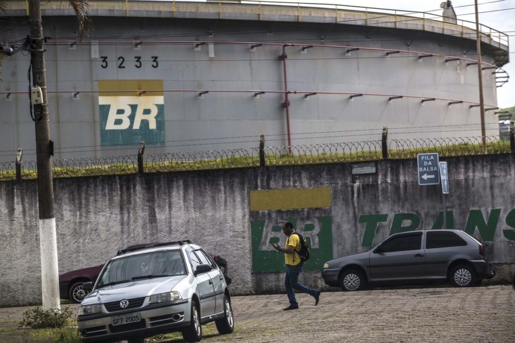 A man walks past an oil storage tank at the Petrobras Transporte SA (Transpetro) sea terminal in Sao Sebastiao, Sao Paulo state, Brazil, on Wednesday, Dec. 19, 2018.  Photographer: Dado Galdieri/Bloomberg