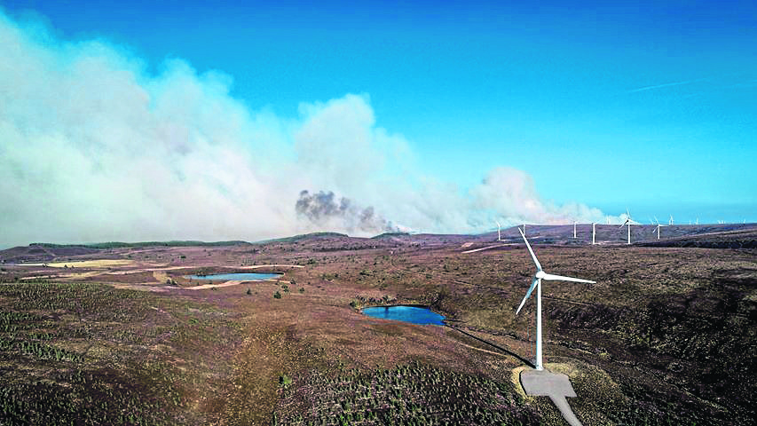 Smoke can be seen filling the sky as the wildfire creeps nearer to the turbines of Paul’s Hill Wind Farm at Knockando. Pictures courtesy of William Bird