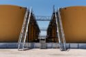 Separator tanks stand at the Royal Dutch Shell Plc processing facility in Loving, Texas, U.S., on Friday, Aug. 24, 2018. Royal Dutch Shell Plc came through a quarter of volatile oil prices to beat earnings estimates, delivering a surge in cash flow the company said will underpin "world-class" returns to investors. Photographer: Callaghan O'Hare/Bloomberg