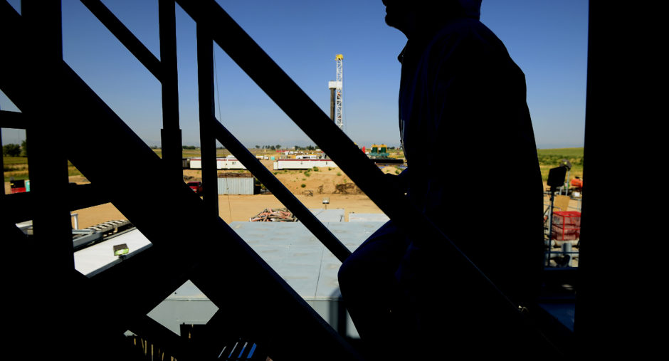 The silhouette of a contractor is seen walking up stairs at an Anadarko Petroleum Corp. oil rig site in Fort Lupton, Colorado. Photographer: Jamie Schwaberow/Bloomberg