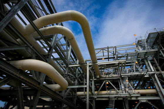 Gas pipes run through a plant at the Queensland Curtis Liquefied Natural Gas (QCLNG) project site, operated by QGC Pty, a unit of Royal Dutch Shell Plc, in Gladstone, Australia, on Wednesday, June 15, 2016. Gas from more than 2,500 wells travels hundreds of miles by pipeline to the project, where it's chilled and pumped into 10-story-high tanks before being loaded onto massive ships. Photographer: Patrick Hamilton /Bloomberg