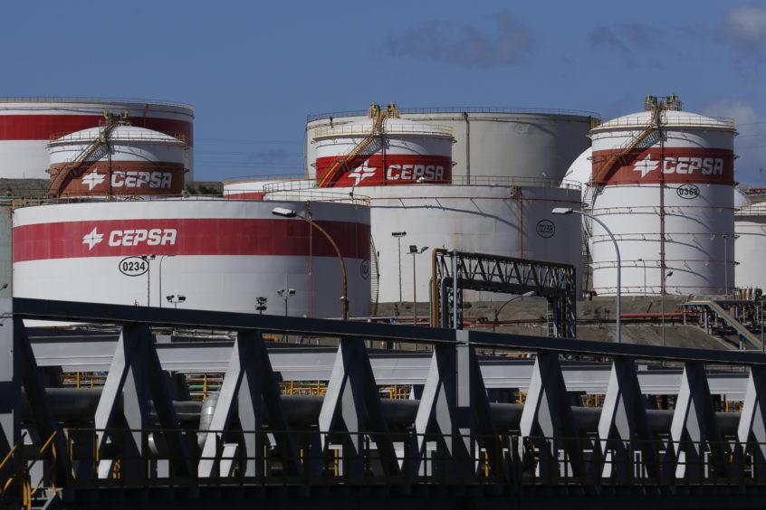 Oil storage tanks sit at the water's edge at the Cia. Espanola de Petroleos (CEPSA) refinery in Algeciras, Spain, on Sunday, March 6, 2016.  Photographer: Luke MacGregor/Bloomberg