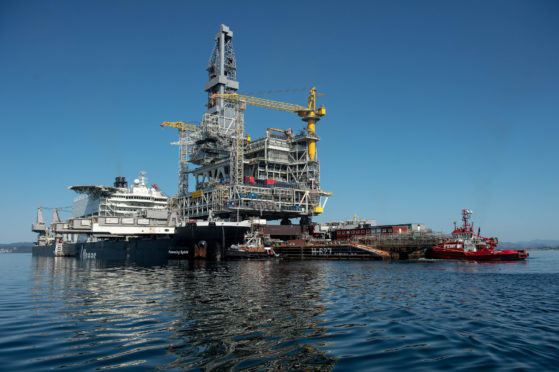 The H-627 barge carrier transports an oil drilling platform onto the world's largest construction vessel, the Pioneering Spirit, in the Bomla fjord near Leirvik, ahead of its transportation to the Johan Sverdrup oil field, Norway, on Friday, June 1, 2018. Photographer: Carina Johansen/Bloomberg