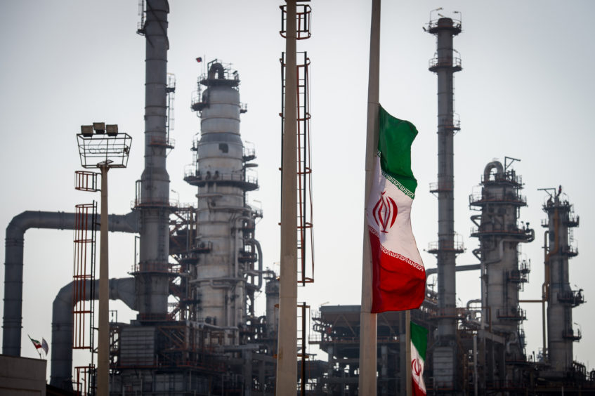 An Iranian national flag flies near gas condensate processing facilities in the new Phase 3 facility at the Persian Gulf Star Co. (PGSPC) refinery in Bandar Abbas, Iran, on Wednesday, Jan. 9. 2019. 
Photographer: Ali Mohammadi/Bloomberg