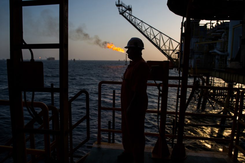 A gas flame burns from a pipe close to an offshore oil platform in the Persian Gulf's Salman Oil Field, operated by the National Iranian Offshore Oil Co., near Lavan island, Iran.