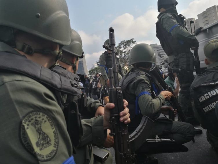 A group of National Guard members supporting Venezuelan opposition leader Juan Guaido gather during a military uprising near the La Carlota base in Caracas, Venezuela, on Tuesday, April 30, 2019. Guaido on Tuesday went to a military base in the nation's capital to proclaim the end of socialist President Nicolas Maduro's regime and called for a military uprising. Photographer: Carlos Becerra/Bloomberg