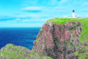 Cape Wrath, the most northwesterly point of the UK mainland. The lighthouse, built in 1828, sits above a massive, richly coloured rockface and provides a beacon for shipping passing between the North Atlantic Ocean and the North Sea.