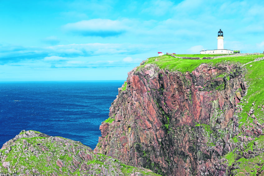 Cape Wrath, the most northwesterly point of the UK mainland. The lighthouse, built in 1828, sits above a massive, richly coloured rockface and provides a beacon for shipping passing between the North Atlantic Ocean and the North Sea.