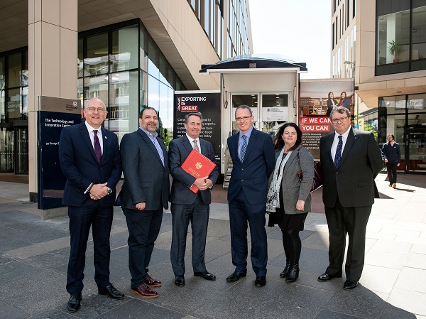 EIC CEO Stuart Broadley (left), International Trade Secretary Dr Liam Fox MP (centre-left with red folder)