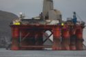 3 Greenpeace climbers on BP oil rig in Cromarty Firth, Scotland