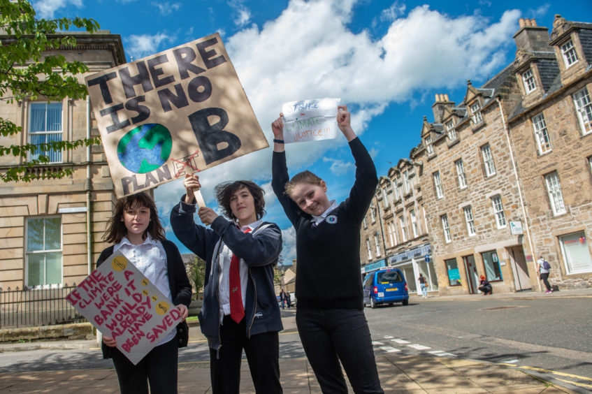 Bria Alexandra, 12, Martha Allsop, 13, Hannah Weir,12, protesting outside Moray Council