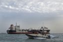 A picture taken on July 21, 2019, shows Iranian Revolutionary Guards patrolling around the British-flagged tanker Stena Impero as it's anchored off the Iranian port city of Bandar Abbas. - Iran warned Sunday that the fate of a UK-flagged tanker it seized in the Gulf depends on an investigation, as Britain said it was considering options in response to the standoff. Authorities impounded the Stena Impero with 23 crew members aboard off the port of Bandar Abbas after the Islamic Revolutionary Guard Corps seized it Friday in the highly sensitive Strait of Hormuz. (Photo by Hasan Shirvani / MIZAN NEWS AGENCY / AFP)        (Photo credit should read HASAN SHIRVANI/AFP/Getty Images)
