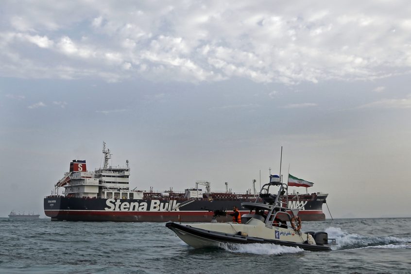 A picture taken on July 21, 2019, shows Iranian Revolutionary Guards patrolling around the British-flagged tanker Stena Impero as it's anchored off the Iranian port city of Bandar Abbas. - Iran warned Sunday that the fate of a UK-flagged tanker it seized in the Gulf depends on an investigation, as Britain said it was considering options in response to the standoff. Authorities impounded the Stena Impero with 23 crew members aboard off the port of Bandar Abbas after the Islamic Revolutionary Guard Corps seized it Friday in the highly sensitive Strait of Hormuz. (Photo by Hasan Shirvani / MIZAN NEWS AGENCY / AFP)        (Photo credit should read HASAN SHIRVANI/AFP/Getty Images)