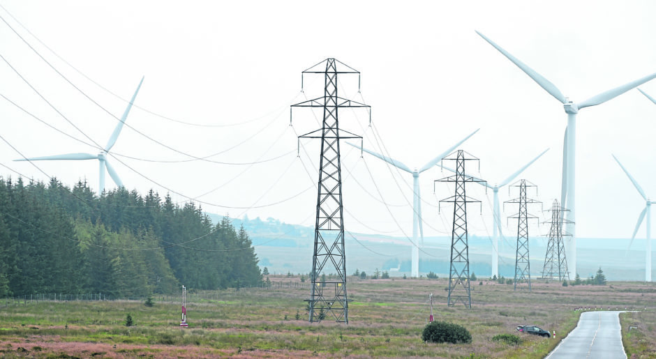 Wind turbines and the pylons that carry their electricity on the Causeymire, Caithness