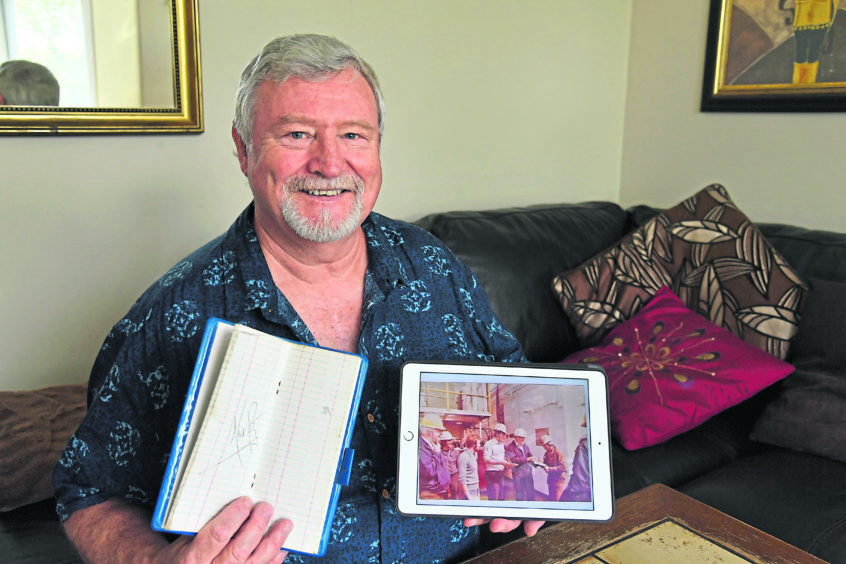 ROCKET to rig: Alan Roy with the picture that was snapped as he laughed with Neil Armstrong and the notebook that the astronaut signed