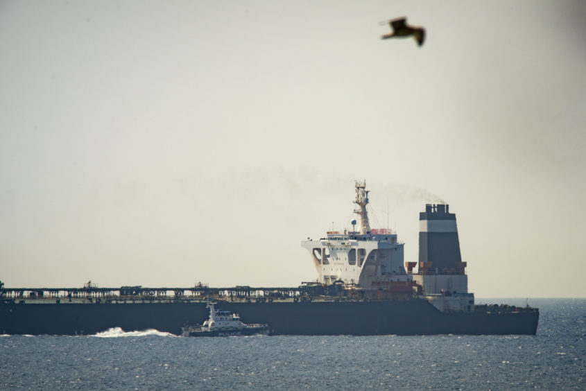 A view of the Grace 1 super tanker in the British territory of Gibraltar, Thursday, July 4, 2019. Spain's acting foreign minister says a tanker stopped off Gibraltar and suspected of taking oil to Syria was intercepted by British authorities after a request from the United States. (AP Photo/Marcos Moreno)