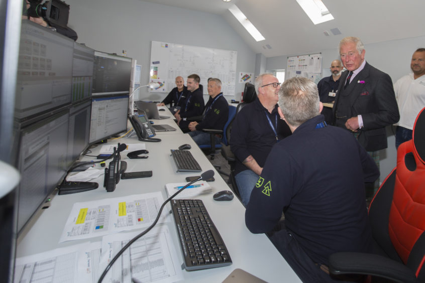 Prince Charles chats with marine co-ordinator Colin Brown and Gordon Morrison in the Beatrice Offshore Windfarm control room at Wick Harbour. Photo: Robert MacDonald/Northern Studios