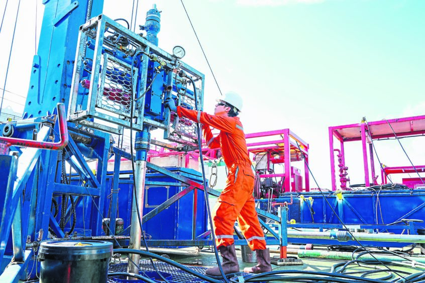 Offshore oil and gas industry, worker inspect and setting up top side tools for safety first to perforation oil and gas production well.
