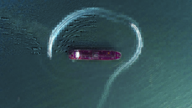 In this Sunday, July 21, 2019 photo, an aerial view shows a speedboat of Iran's Revolutionary Guard moving around the British-flagged oil tanker Stena Impero which was seized in the Strait of Hormuz on Friday by the Guard, in the Iranian port of Bandar Abbas. Global stock markets were subdued Monday while the price of oil climbed as tensions in the Persian Gulf escalated after Iran's seizure of a British oil tanker on Friday. (Morteza Akhoondi/Tasnim News Agency via AP)