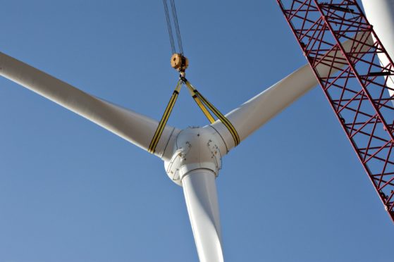A rotor assembly is raised into position during construction of of a wind turbine at the Edison Mission Group Big Sky wind farm in Ohio, Illinois, U.S., on Wednesday, Sept. 29, 2010. When complete, the Big Sky wind farm, owned by Edison Mission Group, a subsidiary of Edison International Co., will contain 114 Suzlon Energy Ltd. turbines capable of producing a total of 240 megawatts of electricity. Photographer: Daniel Acker/Bloomberg