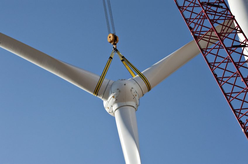 A rotor assembly is raised into position during construction of of a wind turbine at the Edison Mission Group Big Sky wind farm in Ohio, Illinois, U.S., on Wednesday, Sept. 29, 2010. When complete, the Big Sky wind farm, owned by Edison Mission Group, a subsidiary of Edison International Co., will contain 114 Suzlon Energy Ltd. turbines capable of producing a total of 240 megawatts of electricity. Photographer: Daniel Acker/Bloomberg